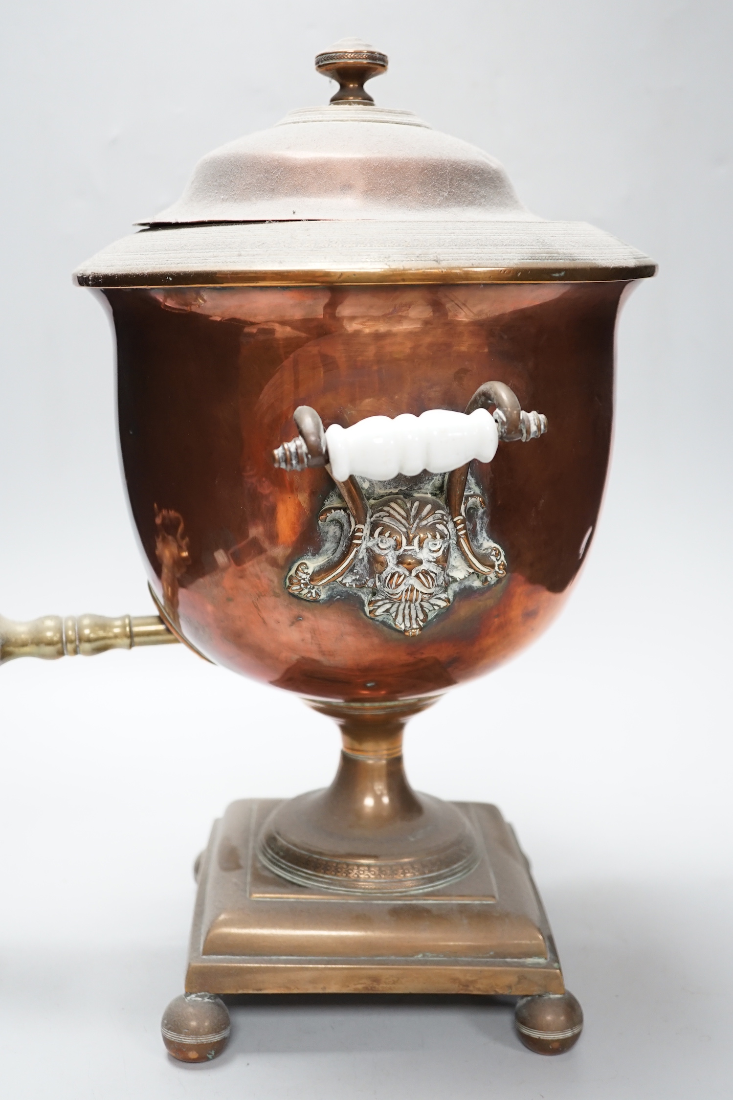 A copper tea urn with brass spigot tap and handles, 44cm